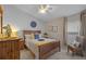 Bright bedroom featuring a wooden bed frame, dresser, and a window with natural light at 7634 Nottinghill Sky Dr, Apollo Beach, FL 33572