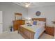 Charming bedroom with a wooden bed frame, light-colored walls, and wood dresser at 7634 Nottinghill Sky Dr, Apollo Beach, FL 33572