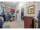 Walk-in closet featuring custom shelving, ample storage, and a full-length mirror at 7634 Nottinghill Sky Dr, Apollo Beach, FL 33572