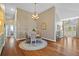 Charming dining area with a chandelier, round rug, and views to the foyer and entry at 7634 Nottinghill Sky Dr, Apollo Beach, FL 33572