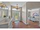 Bright foyer with hardwood floors and decorative mirror at 7634 Nottinghill Sky Dr, Apollo Beach, FL 33572