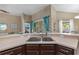 Kitchen sink area with a view of the lanai and bar seating at 7634 Nottinghill Sky Dr, Apollo Beach, FL 33572