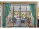 Inviting lanai with comfortable seating, view to pool, and access to the outdoors at 7634 Nottinghill Sky Dr, Apollo Beach, FL 33572