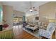 Open concept living room with hardwood floors and views of the pool at 7634 Nottinghill Sky Dr, Apollo Beach, FL 33572
