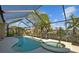 Sparkling pool and spa surrounded by lush landscaping, perfect for outdoor enjoyment at 7634 Nottinghill Sky Dr, Apollo Beach, FL 33572
