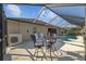 Outdoor dining and seating on a patio by a pool featuring a hot tub, and a screen enclosure at 7634 Nottinghill Sky Dr, Apollo Beach, FL 33572