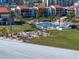 Aerial view of the community featuring a pool, barbecue area and lush landscaping at 825 S Gulfview Blvd # 208, Clearwater Beach, FL 33767
