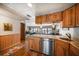 Kitchen featuring wood cabinetry, granite countertops, and opening into the spacious living room with waterfront views at 825 S Gulfview Blvd # 208, Clearwater Beach, FL 33767