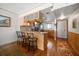 Cozy kitchen featuring light wood cabinets, granite countertops, breakfast bar, and wood flooring at 825 S Gulfview Blvd # 208, Clearwater Beach, FL 33767