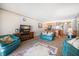 Comfortable living room featuring blue couches, carpet, and views into the updated kitchen at 825 S Gulfview Blvd # 208, Clearwater Beach, FL 33767