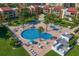 Aerial view of the community pool, surrounding lounging area and lush landscaping at 825 S Gulfview Blvd # 208, Clearwater Beach, FL 33767