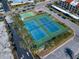 Aerial view of well maintained tennis courts in a landscaped setting at 825 S Gulfview Blvd # 208, Clearwater Beach, FL 33767