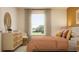 Well-lit bedroom featuring a stylish dresser, soft linens, and a bright, airy atmosphere at 9304 Bonita Mar Dr, Parrish, FL 34219