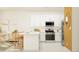 Open-concept kitchen featuring stainless steel appliances, white cabinets, and a kitchen island at 9304 Bonita Mar Dr, Parrish, FL 34219
