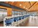 Modern bar with a white countertop, blue chairs, pendant lighting and a large window with beautiful water views at 9425 Blind Pass Rd # 507, St Pete Beach, FL 33706