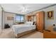 Comfortable bedroom featuring a queen bed, ceiling fan, built-in wardrobe, and scenic view at 9425 Blind Pass Rd # 507, St Pete Beach, FL 33706