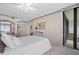Bright bedroom featuring a queen bed, built-in wardrobe, and sliding glass doors at 9425 Blind Pass Rd # 507, St Pete Beach, FL 33706