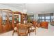 This dining room features a round table, four chairs, built-in hutch, and sliding glass doors at 9425 Blind Pass Rd # 507, St Pete Beach, FL 33706