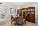 This dining room features a round table, four chairs, built-in hutch, and artwork at 9425 Blind Pass Rd # 507, St Pete Beach, FL 33706