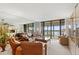 Spacious living room with floor to ceiling windows providing an abundance of natural light at 9425 Blind Pass Rd # 507, St Pete Beach, FL 33706