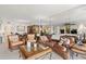 Bright living room featuring a leather sofa, two chairs, glass coffee table, and mirrored wall at 9425 Blind Pass Rd # 507, St Pete Beach, FL 33706