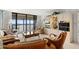 Inviting living room featuring comfortable seating, a entertainment center, and a scenic view from the balcony at 9425 Blind Pass Rd # 507, St Pete Beach, FL 33706