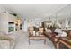 Bright living room featuring a leather sofa, two chairs, glass coffee table, and entertainment center at 9425 Blind Pass Rd # 507, St Pete Beach, FL 33706