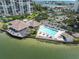 An aerial view of the community pool, offering a relaxing retreat with lounge chairs and picturesque waterfront views at 9425 Blind Pass Rd # 507, St Pete Beach, FL 33706