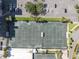 Aerial view of the community tennis courts next to parking and lush landscaped area at 9425 Blind Pass Rd # 507, St Pete Beach, FL 33706