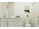 Bright bathroom with a white vanity, a modern sink, a framed mirror, and tub with shower at 9452 Runaway Breeze Dr, Land O Lakes, FL 34637