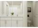 Bright bathroom featuring double sinks, vanity with marble countertops, and a shower at 9452 Runaway Breeze Dr, Land O Lakes, FL 34637
