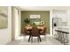 Modern dining room with a large table, brown chairs, and a kitchen with stainless steel appliances at 9452 Runaway Breeze Dr, Land O Lakes, FL 34637