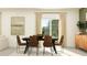 Bright dining room featuring a table, chairs, and a slider door with a view of the backyard at 9452 Runaway Breeze Dr, Land O Lakes, FL 34637
