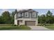 Charming two-story home with blue siding, a well-manicured lawn, and an attached two-car garage at 9452 Runaway Breeze Dr, Land O Lakes, FL 34637