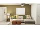 Comfortable living room with a sectional sofa, stylish cushions, and a modern lamp at 9452 Runaway Breeze Dr, Land O Lakes, FL 34637