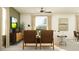 Cozy living room featuring comfortable seating, a ceiling fan, and decorative accents at 9452 Runaway Breeze Dr, Land O Lakes, FL 34637