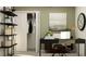 Well-lit office with a minimalist desk, shelving, decor and a view of the closet at 9452 Runaway Breeze Dr, Land O Lakes, FL 34637