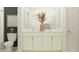 Elegant bathroom featuring double sinks, marble countertops, and a decorative flower arrangement at 9455 Runaway Breeze Dr, Land O Lakes, FL 34637