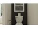 Cozy powder room boasts modern fixtures, a sleek toilet, and contemporary artwork at 9455 Runaway Breeze Dr, Land O Lakes, FL 34637