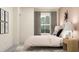 Serene bedroom with artwork and a stylish headboard. Natural light fills the space at 9455 Runaway Breeze Dr, Land O Lakes, FL 34637