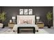 Serene bedroom features a stylish upholstered bed, matching nightstands, and modern wall art at 9455 Runaway Breeze Dr, Land O Lakes, FL 34637