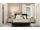 Comfortable bedroom with a dark headboard, patterned pillows, and bedside tables at 9455 Runaway Breeze Dr, Land O Lakes, FL 34637