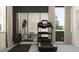 Home gym with treadmill, mirrored wall, weights, and a plant near a window at 9455 Runaway Breeze Dr, Land O Lakes, FL 34637