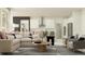 Open-concept living room connected to the kitchen, featuring modern furniture and decor at 9455 Runaway Breeze Dr, Land O Lakes, FL 34637