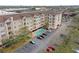 Aerial view of the condo building, pool, parking, and green space at 1216 S Missouri Ave # 224, Clearwater, FL 33756
