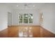 The bedroom has hardwood floors and large windows offering ample natural light with bright walls at 1216 S Missouri Ave # 224, Clearwater, FL 33756