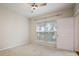 Comfortable bedroom with neutral carpet, window, and a ceiling fan at 1216 S Missouri Ave # 224, Clearwater, FL 33756