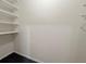 A simple closet interior with white walls, open shelving on the side, and neutral flooring at 1216 S Missouri Ave # 224, Clearwater, FL 33756