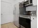 Kitchen features stainless steel appliances, tile flooring, and white cabinets for a modern look at 1216 S Missouri Ave # 224, Clearwater, FL 33756