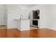 Open floor plan with hardwood floors leads to kitchen and dining with natural light and white walls at 1216 S Missouri Ave # 224, Clearwater, FL 33756
